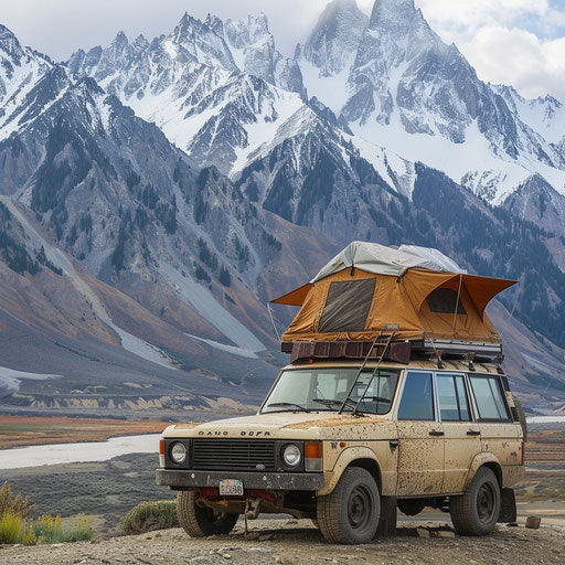 1980 expedition vehicle with rooftop tent against mountain range