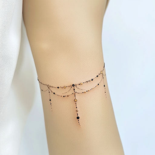 Arm tattoo for females with dainty black and gold chain