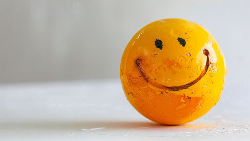 Happy face of an emoticon on white background