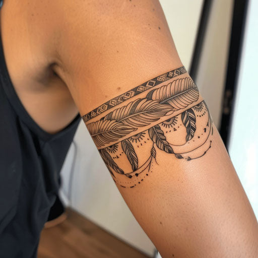 Feathers and tribal patterns tattoo on the arm