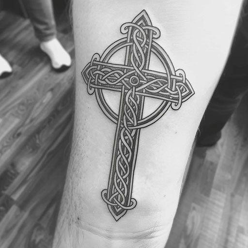 Celtic cross in tribal style, bold lines on white background