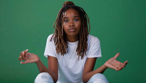 Confusion and uncertainty of a sitting African American woman