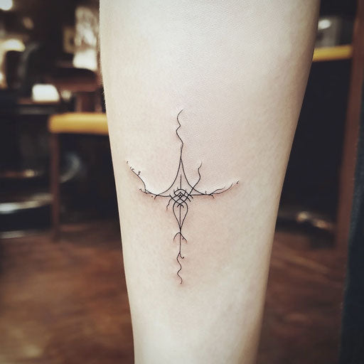Delicate tattoo with a small elven rune, in the style of Peter Jackson