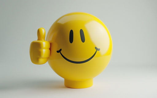 Yellow smiley emoji with thumbs up on white background