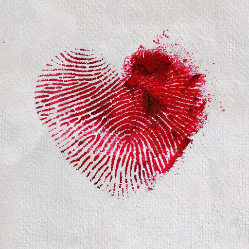 Design of vibrant red fingerprint heart tattoo