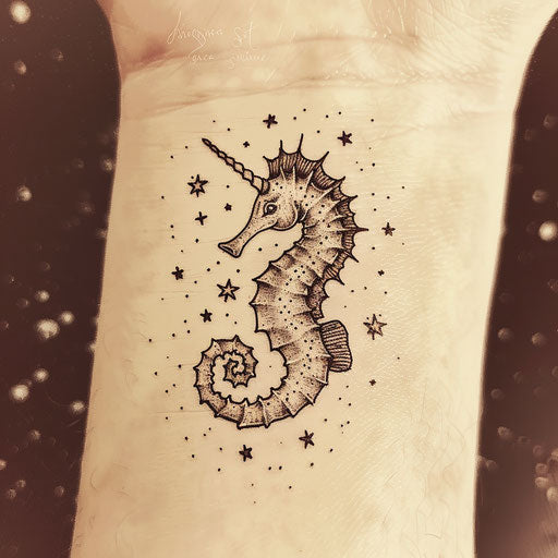 Minimalist tattoo sketch of a seahorse surrounded by stars