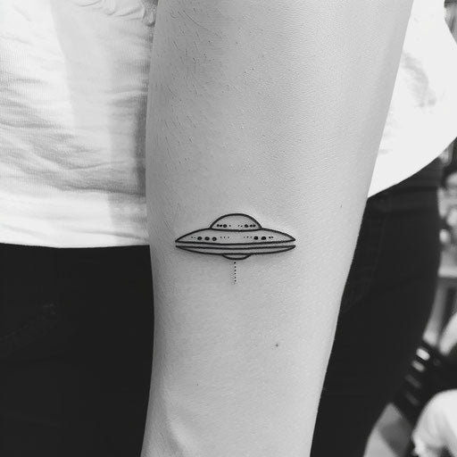 Minimalist UFO tattoo in line art style, simple flying saucer design on white background.