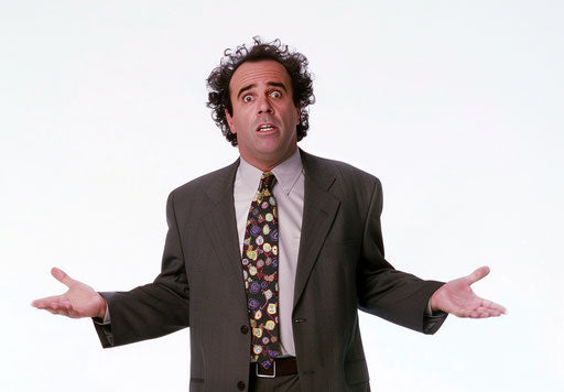 Confused businessman in suit with hands spread out