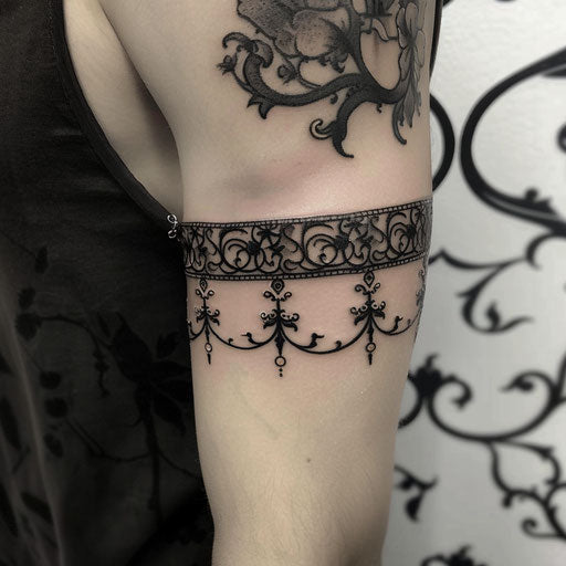 Tattoo armband of gothic symbols and vines on the upper arm