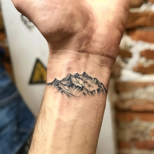 Men's wrist tattoos with minimalist mountains