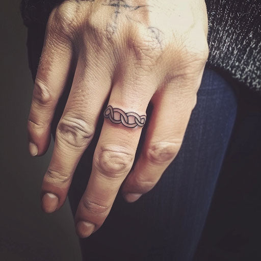 Celtic knot wedding ring tattoo on finger
