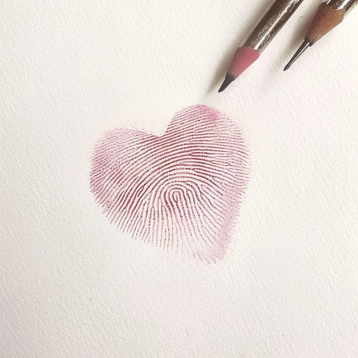 A subtle pink fingerprint heart tattoo drawing on plain white paper