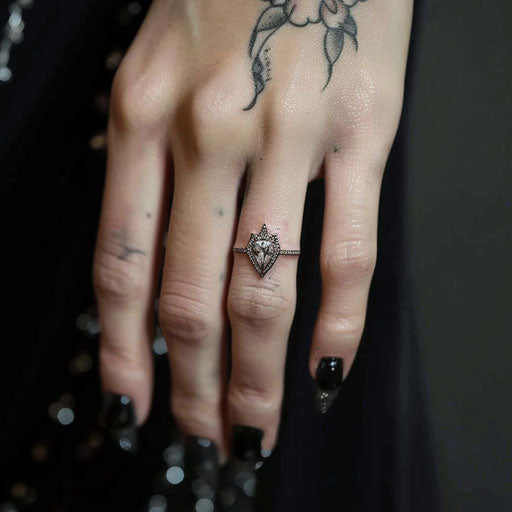 Diamond-shaped wedding ring tattoo on finger