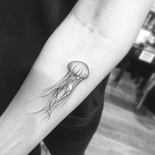 Minimalist jellyfish tattoo on white background