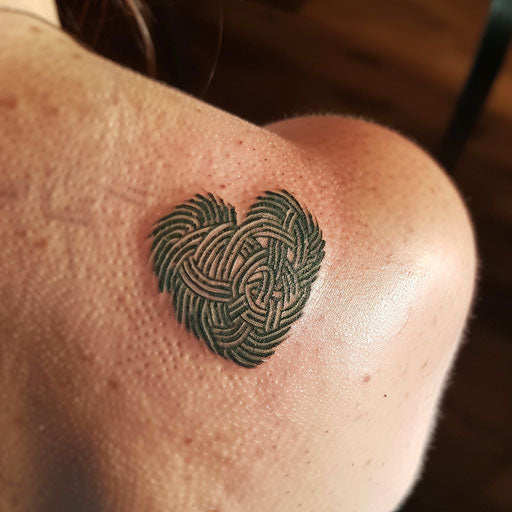 Celtic fingerprint heart tattoo with knotwork detailing