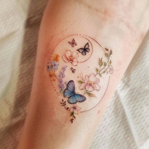 Delicate yin and yang tattoo with soft flowers and butterflies in pastel colors