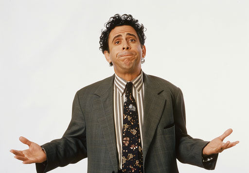 Confused businessman with hands spread out in front