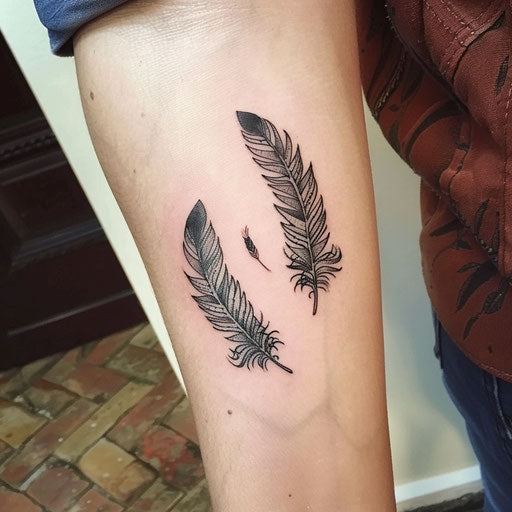 Matching feather and bird tattoos for sisters, Steve McNiven style, on forearm