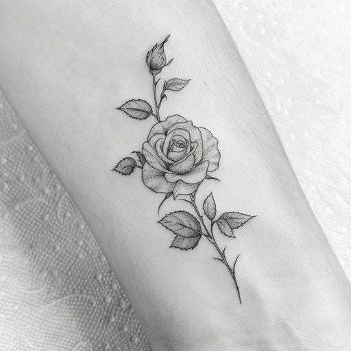 Sketch of a delicate rose with leaves and thorns for wrist coverup tattoo for women