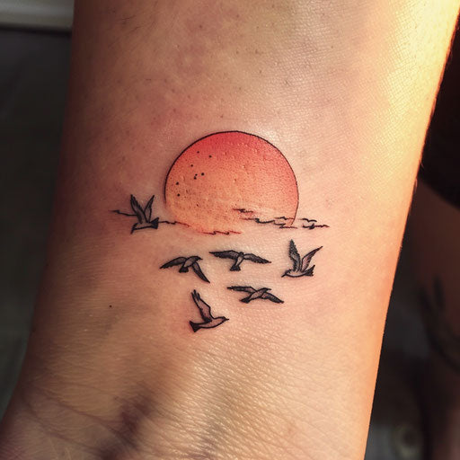 Elegant sunset tattoo with birds flying