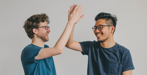 Two people high-fiving in a friendly manner