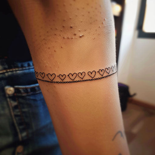 Stylish flat tattoo sketch of a wrist band with a chain of small hearts