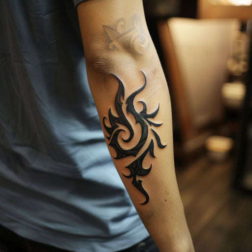 Tribal flames tattoo on elbow, in Humberto Ramos style, on elbow