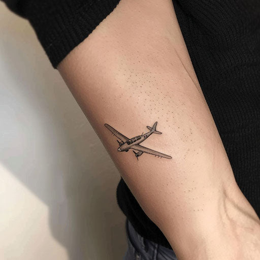 Minimalist airplane tattoo