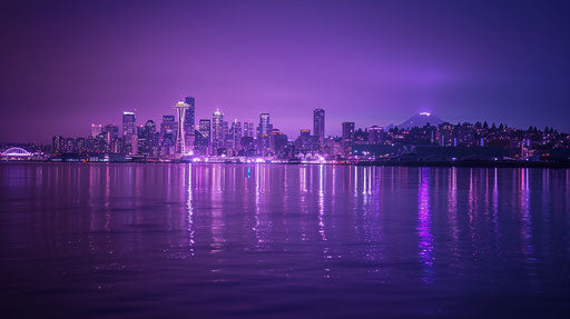 Seattle skyline at night with space needle and Mt Rainier