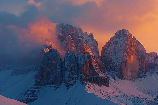 Dolomites in winter at sunset, snow-covered peaks, orange sky