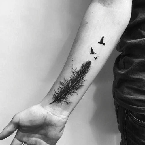 Feather transforming into birds on forearm