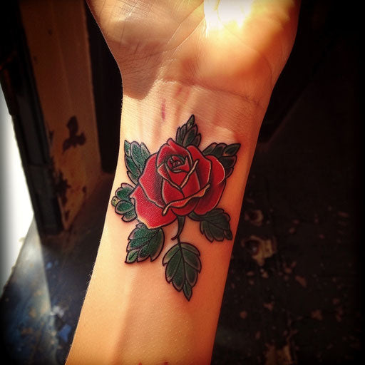 Rose wrist tattoo in the style of Ed Hardy