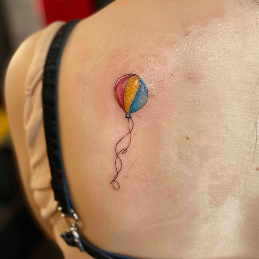 Colorful minimalist tattoo sketch of a balloon floating away in a clear sky, freedom motif