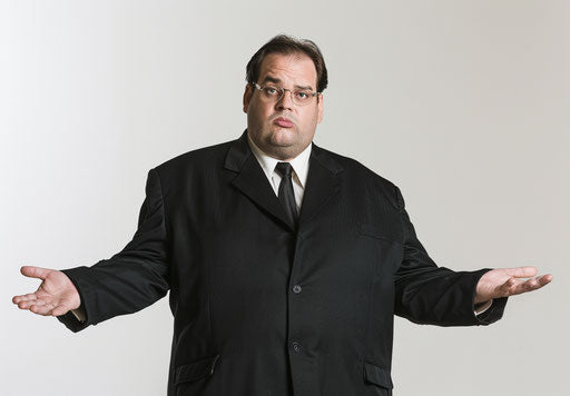Confused overweight businessman in black suit on white background