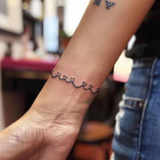 Sleek tattoo sketch of a wrist band with a chain of small, elegant hearts