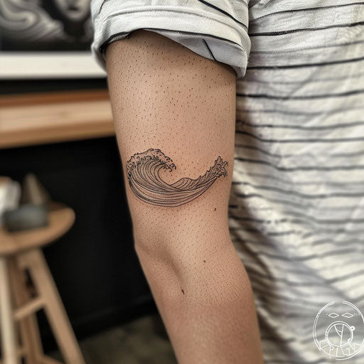 Minimalist waves tattoo on the elbow