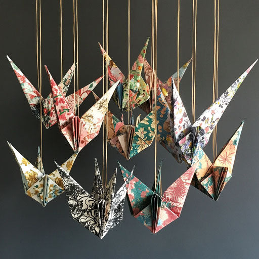 A collection of origami paper crane ornaments