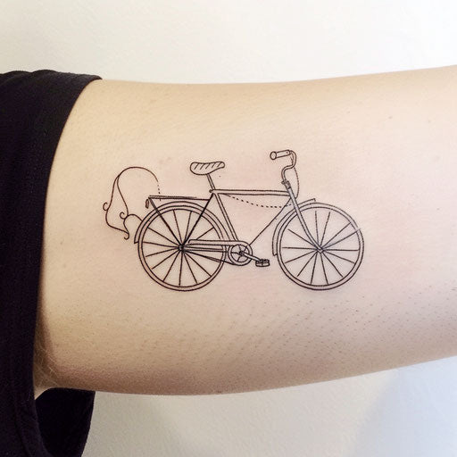 Whimsical flat tattoo sketch of a bicycle drawn with a playful single line