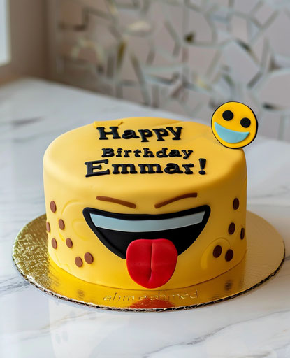 Yellow cake with happy birthday & sticking out tongue emoji.