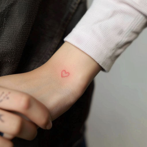 Small minimalist heart tattoo design in red ink