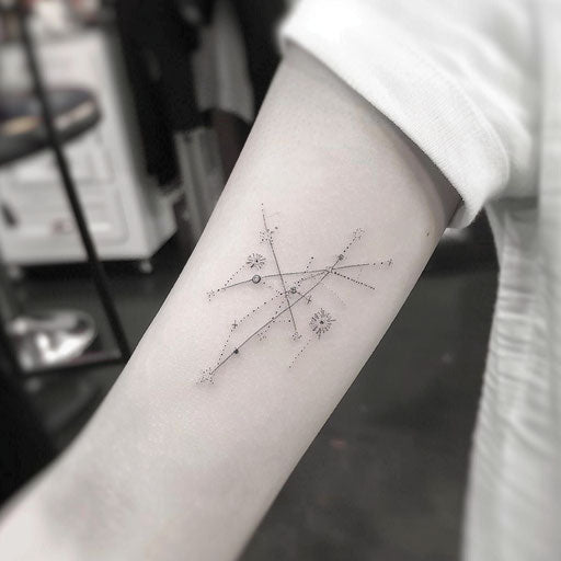Tiny constellation tattoo design with stars connected by thin lines on white background