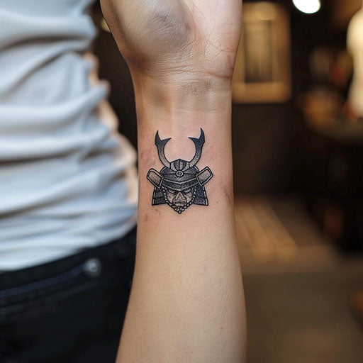 Small wrist tattoos of a samurai helmet, Ami James style