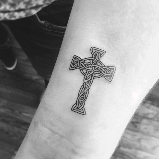 Minimalist Celtic cross in black ink on white background