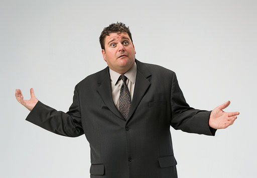 Overweight man in business attire, shrugging and gesturing left