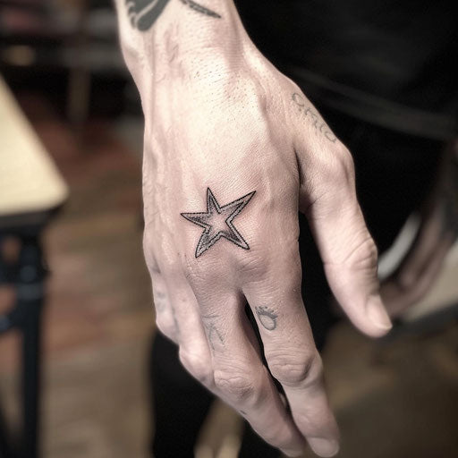 Small hand tattoos of a star, in the style of Steve McNiven