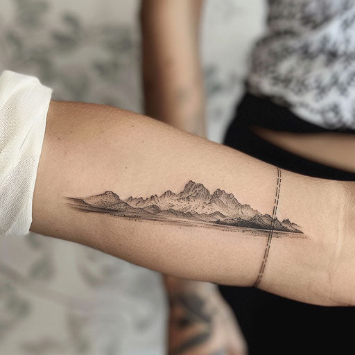 Minimalist mountains and nature armband tattoo on upper arm