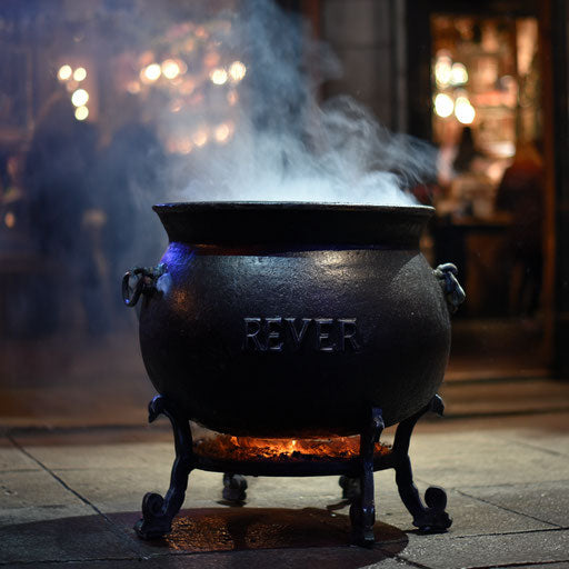 A mysterious orange glowing black cauldron